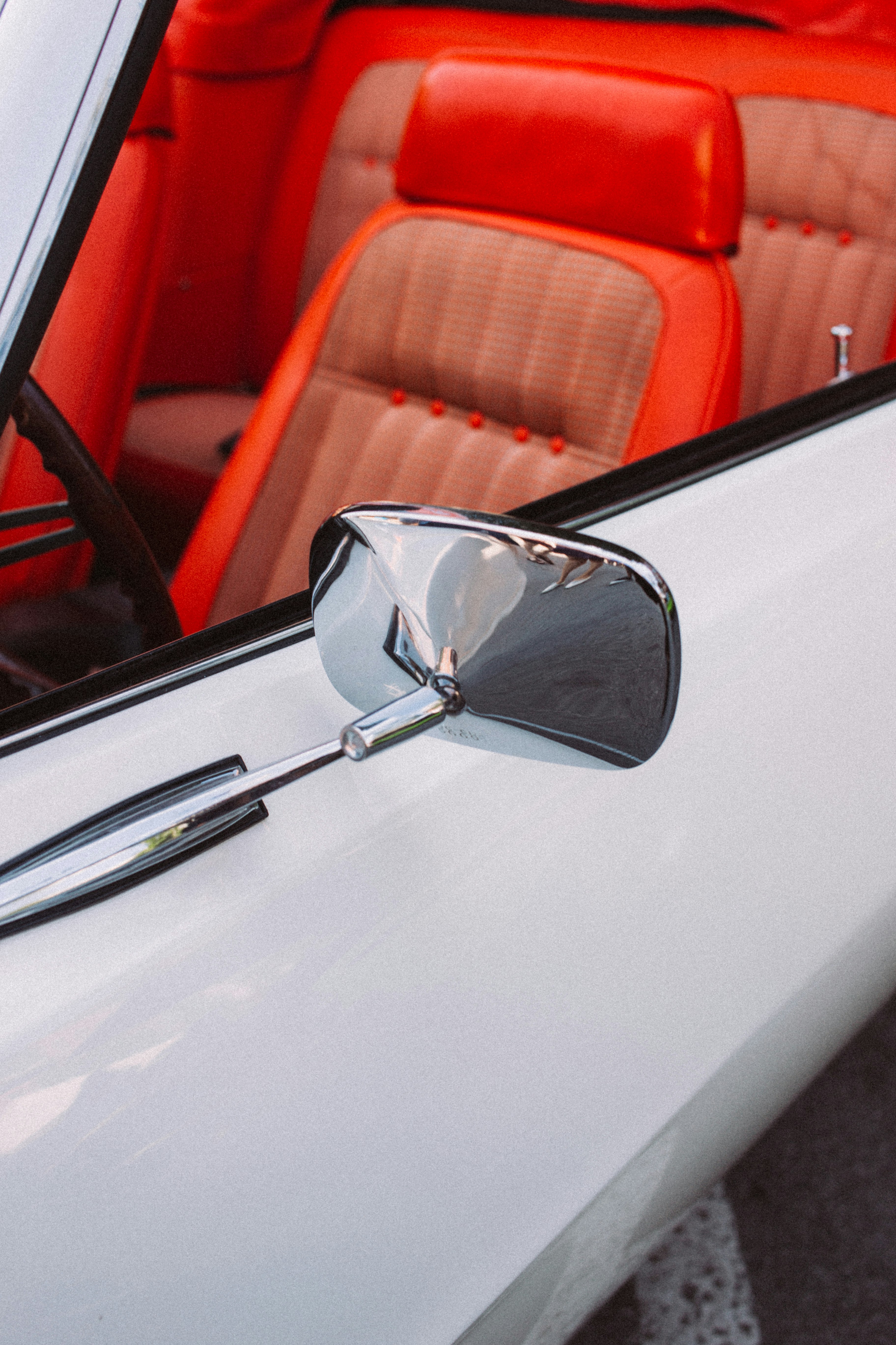 stainless steel rear-view mirror on white car